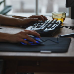 Close up of someone using a mouse and keyboard